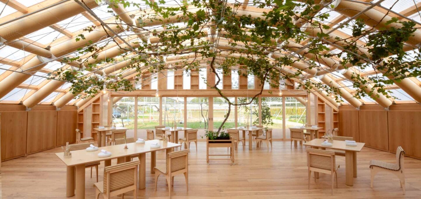 This greenhouse is composed of arches made from paper tubes connected by metal joints. on the exterior, a ready-made greenhouse frame was installed with a double layer of fluorine film with an air layer in between to suppress the temperature changes of the interior. In summer, the leaves of the plants grown inside will cover the ceiling, blocking sunlight completed in 2019 by Shigeru Ban Architects.