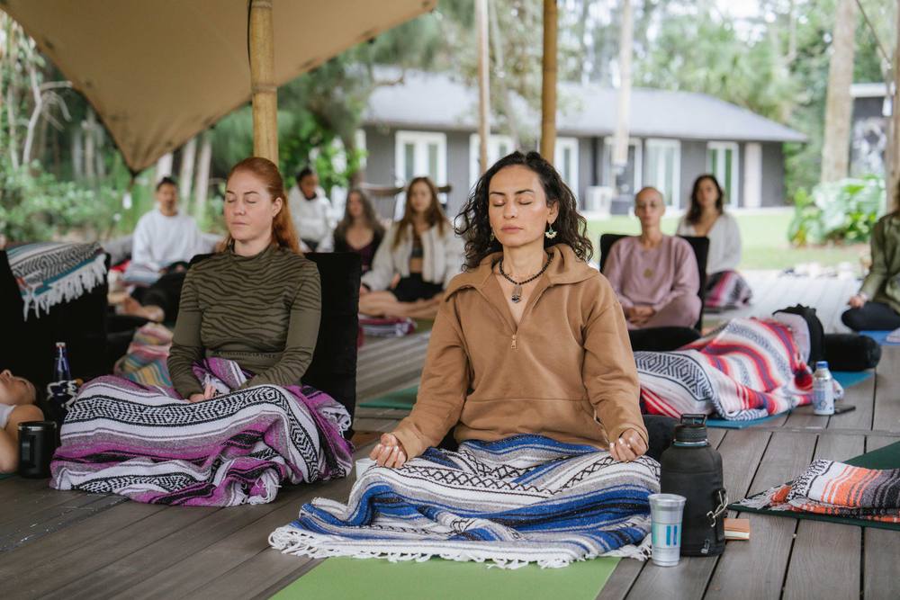 Guests in a group meditation under the tent during a wellness day at ChoZen