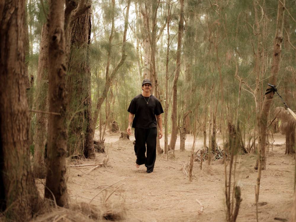 Guest walking barefoot along a pine forest trail at ChoZen