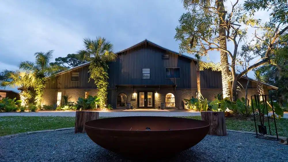 The Harvest House event venue at dusk with a fire bowl at ChoZen