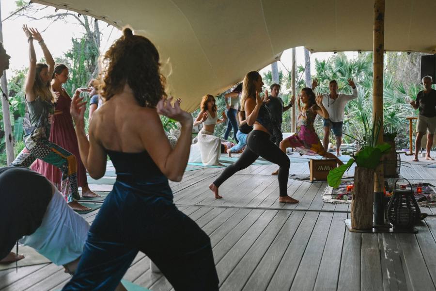 Retreat guests in a yoga session under the tent at ChoZen