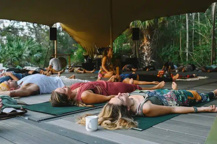 Guests resting in a sound bath under the tent at ChoZen